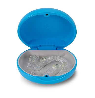 A blue, circular clamshell case for dental retainers or aligners, shown open with a clear aligner inside.