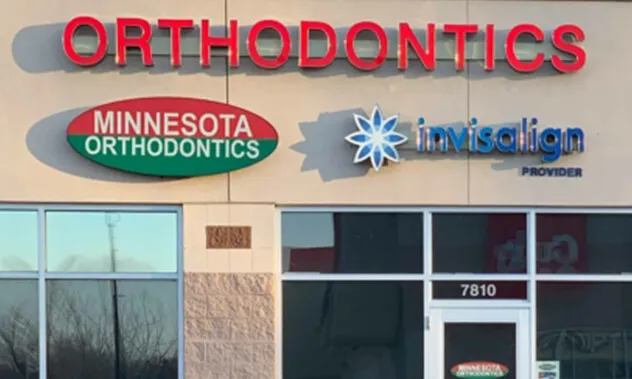 The exterior of the building showing the Orthodontics sign alongside the Blevins and Invisalign logos.