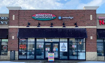 A front-facing shot of the practice entrance in a classic brick building with a dark awning.