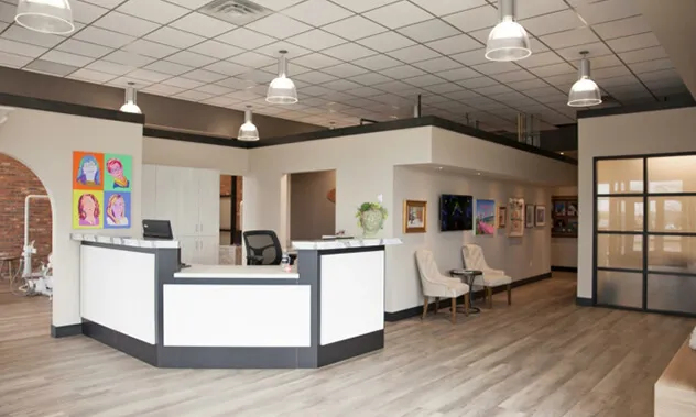 A brick building storefront featuring the Blevins practice logo and large glass windows.