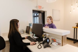 Patient inquiring at the reception area.